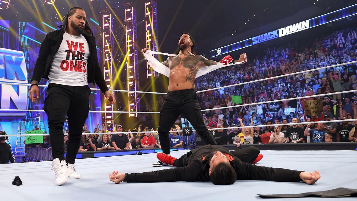 Jimmy and Jey Uso stand tall after hitting Roman Reigns with a tandem Superkick. 