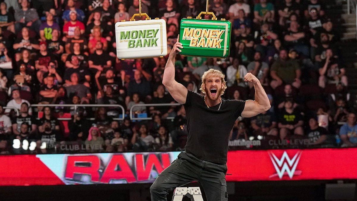 Logan Paul holding up the Money in the Bank briefcase on Raw.