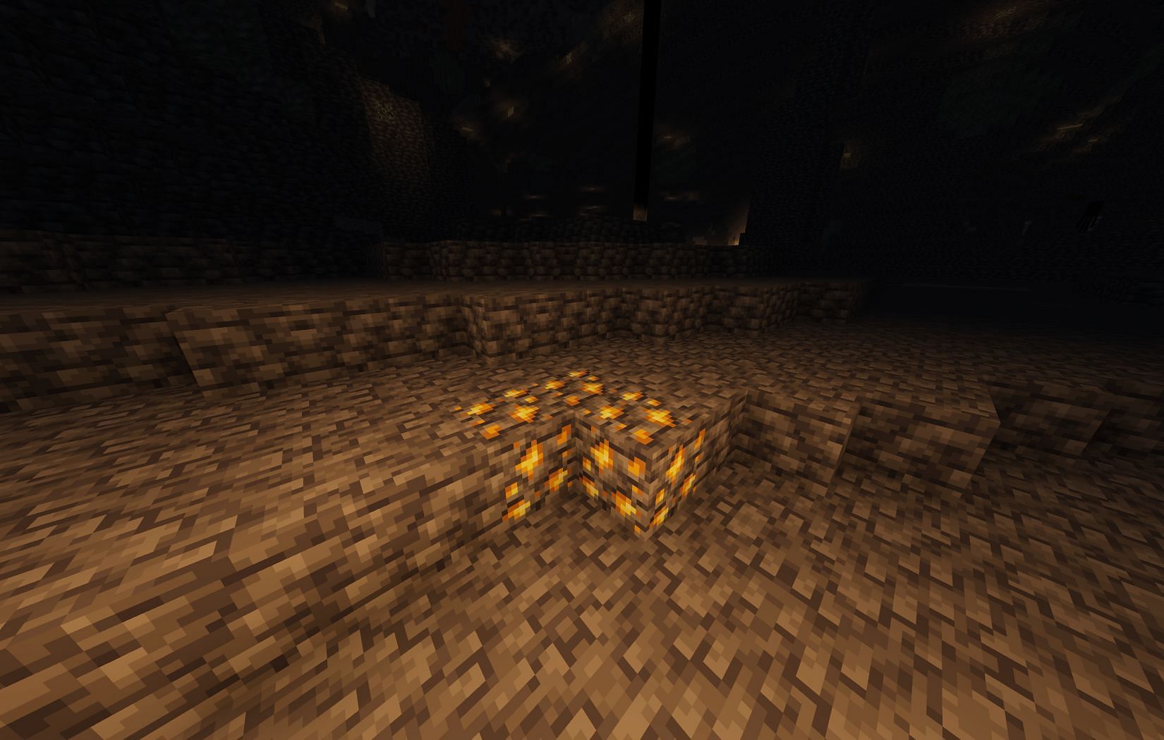 Gold ore naturally found in caves (Image via Mojang)