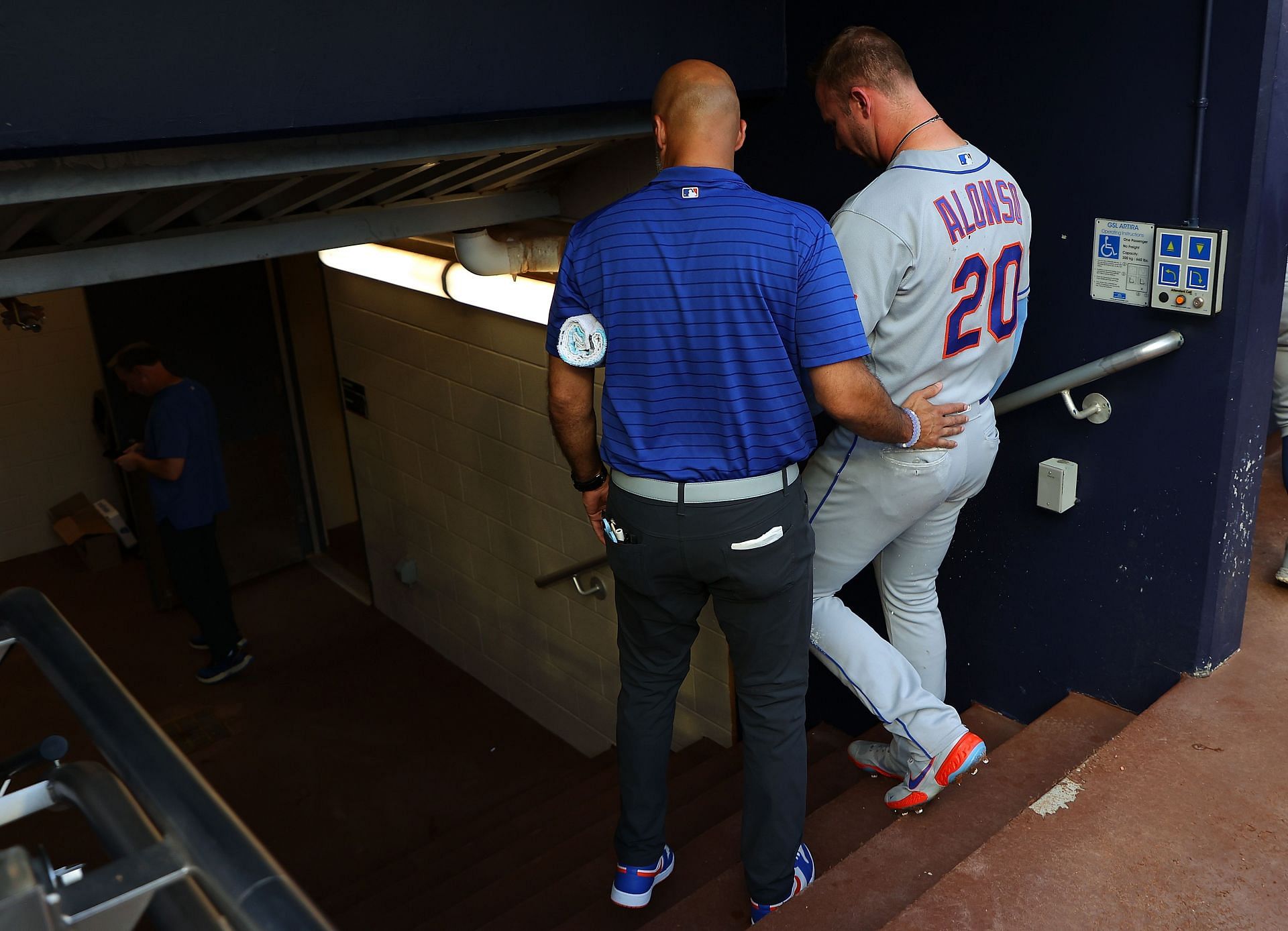 Pete Alonso #20 of the New York Mets walks to the clubhouse with a trainer after he is hit by pitch in the first inning against Charlie Morton #50 of the Atlanta Braves at Truist Park on June 07, 2023