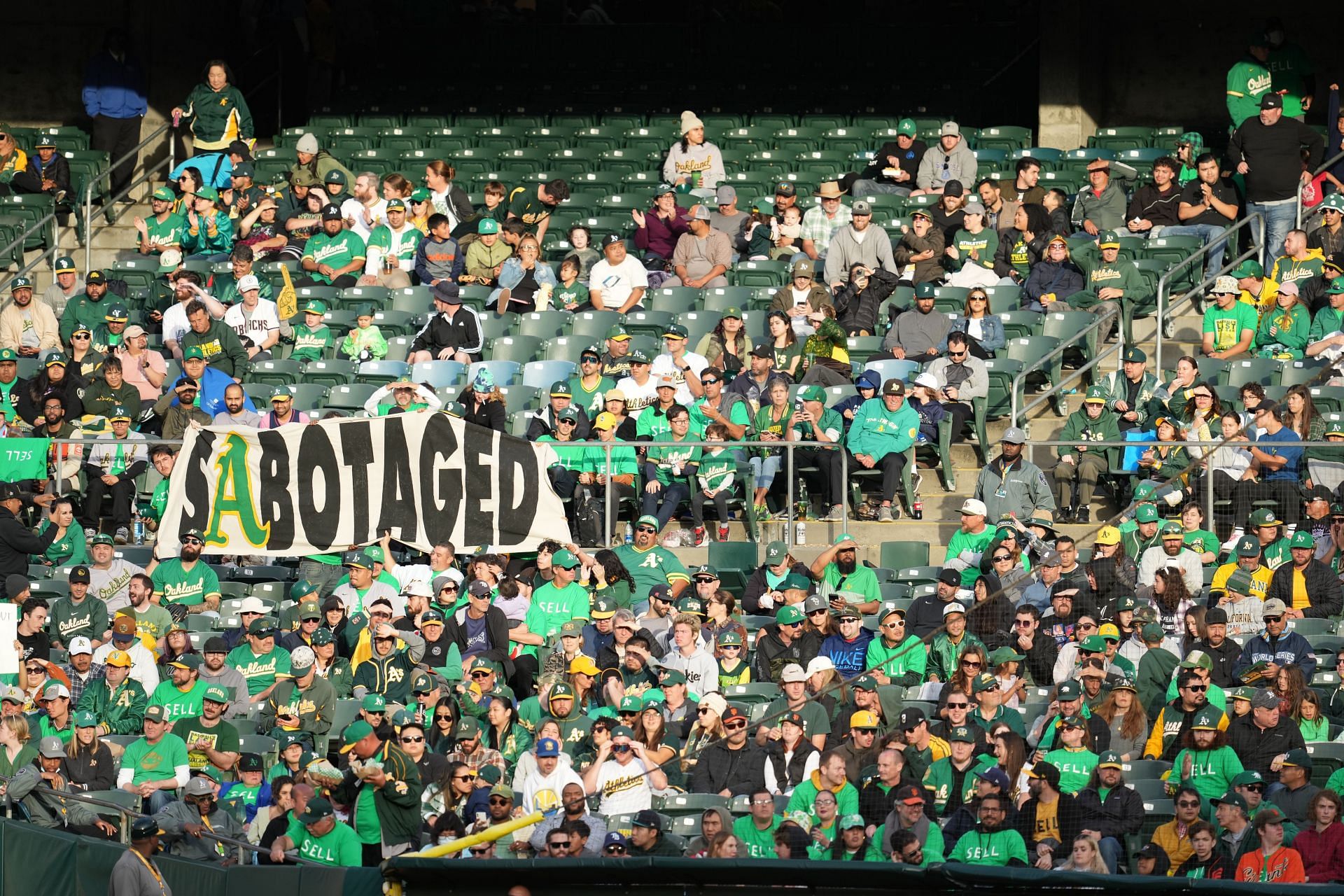 Oakland Athletics fans display signs during a reverse boycott game against the Tampa Bay Rays at RingCentral Coliseum