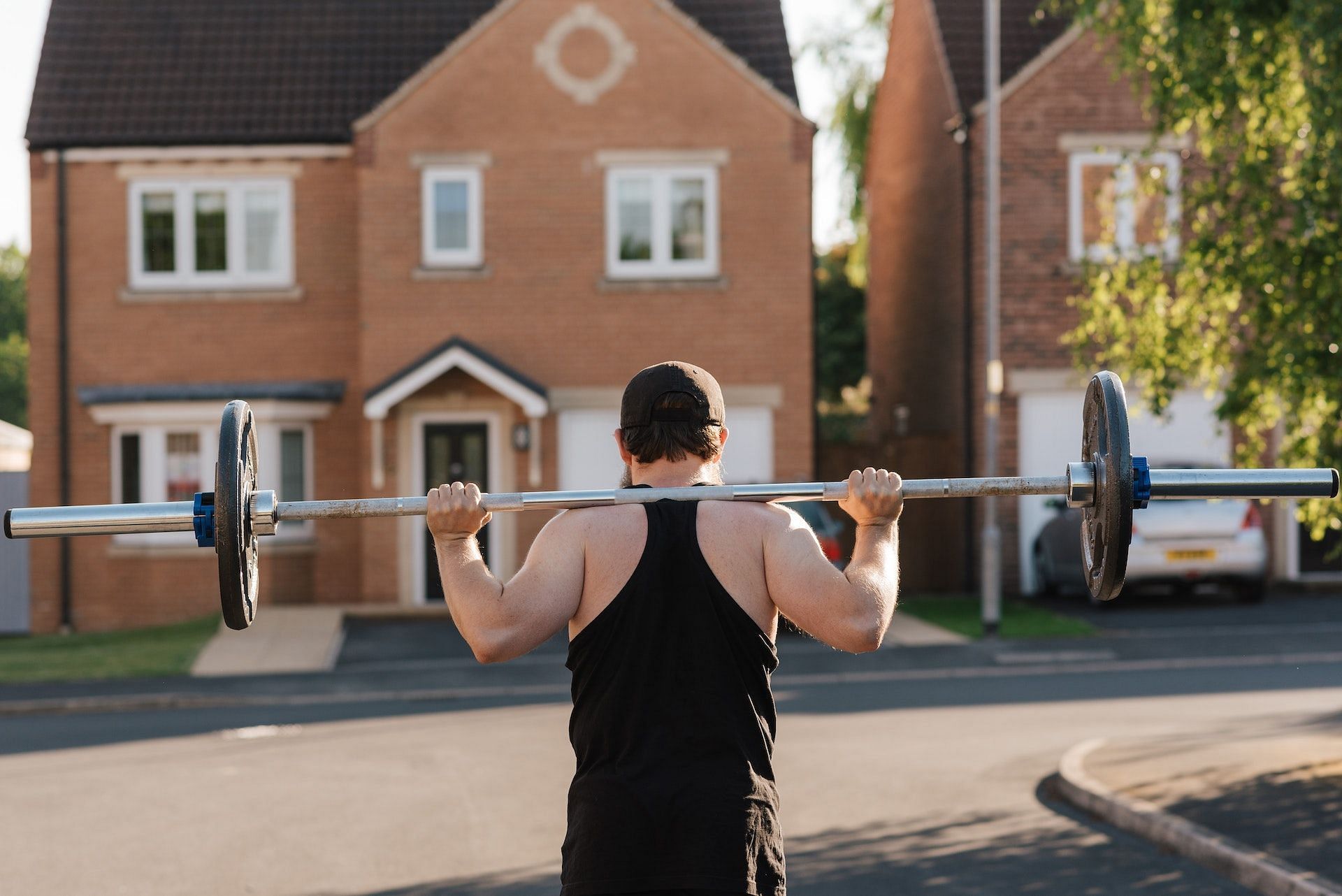 The high bar squat is an effective barbell squat variation. (Photo via Pexels/Anete Lusina)