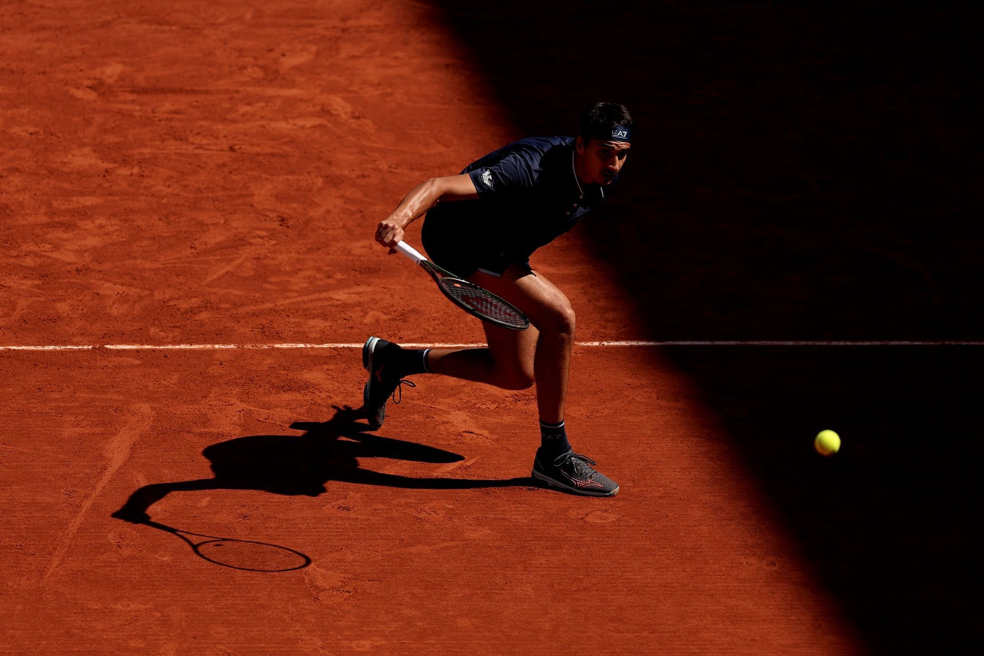 Lorenzo Sonego slices the ball at the 2023 French Open