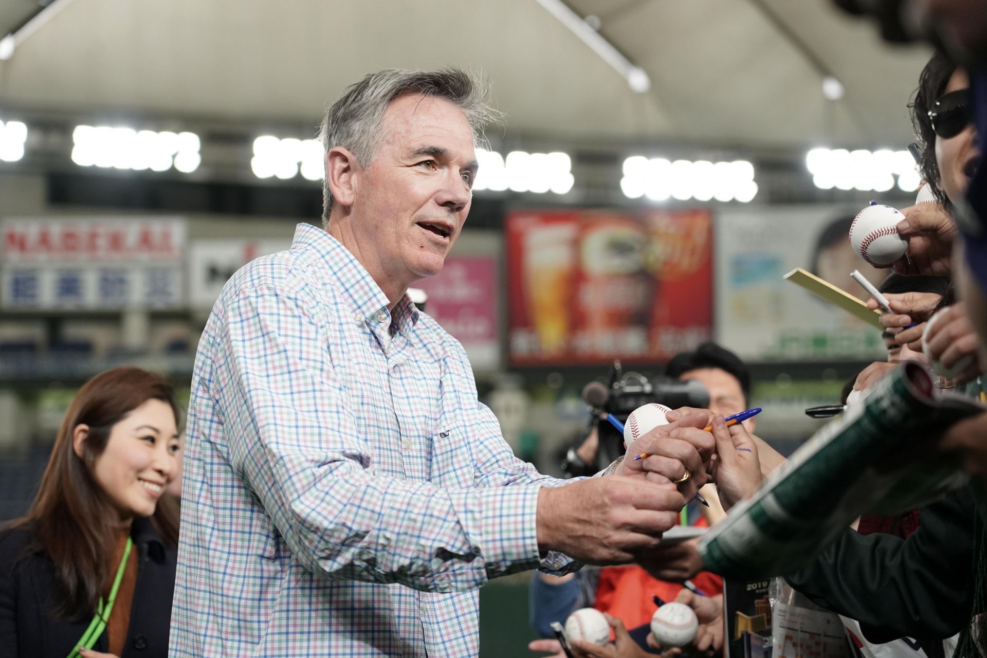 Oakland Athletics' general manager Billy Beane, right, assists