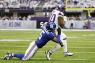 Kayvon Thibodeaux #5 of the New York Giants tackles C.J. Ham #30 of the Minnesota Vikings