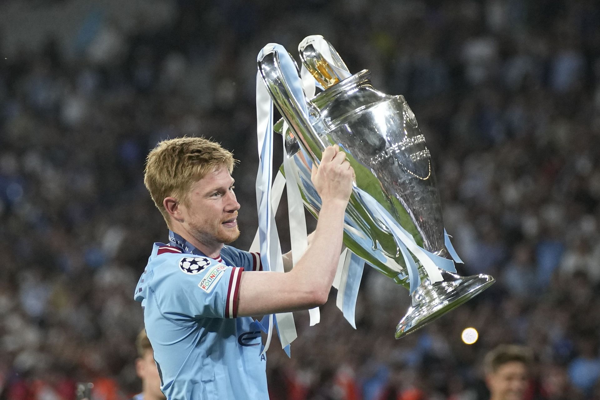Kevin De Bruyne poses with the Champions League trophy