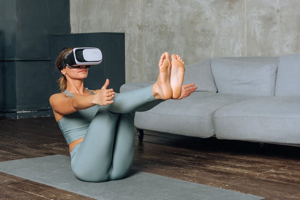 woman goes in for sports in virtual reality using VR glasses(Image via Getty Images)