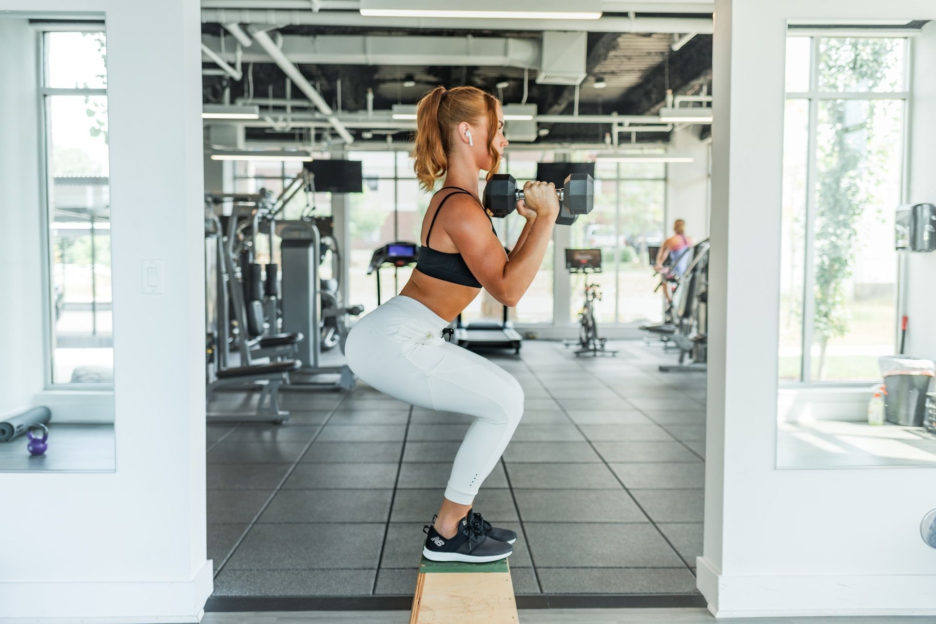 Squats with dumbbells. (Image via Unsplash/ Benjamin Klaver)