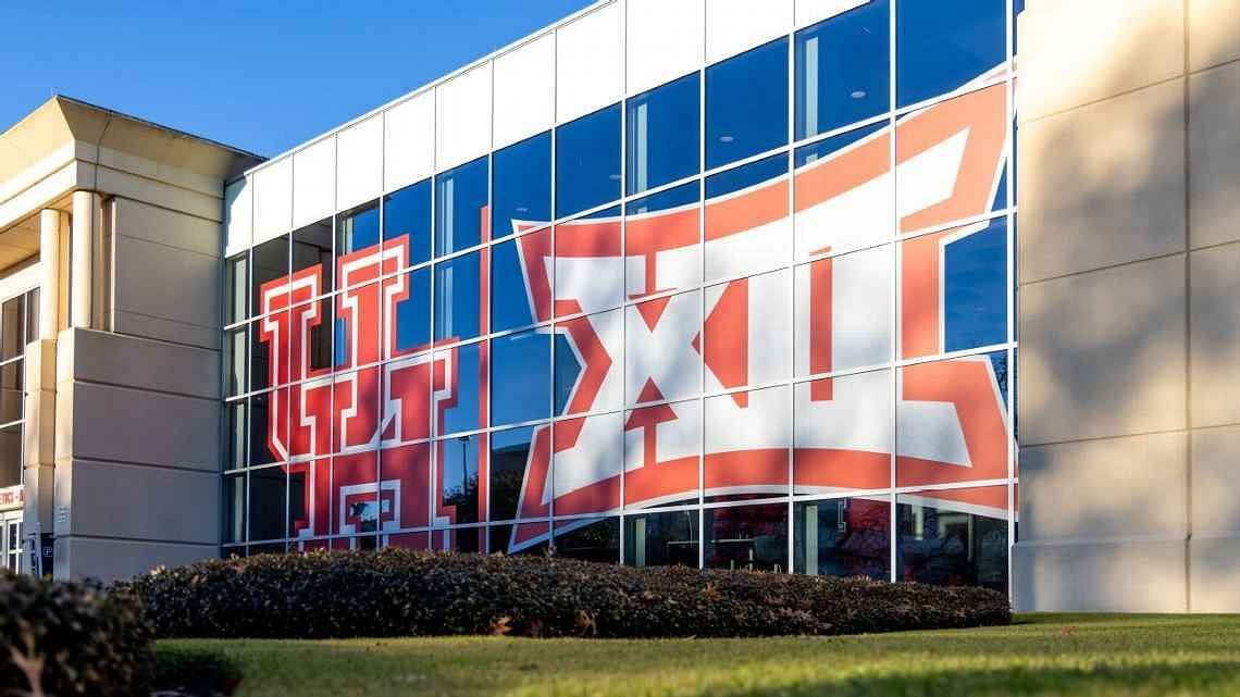 University of Houston logo placed side by side with the Big 12 logo on the window of the Alumni Center athletics facility.w