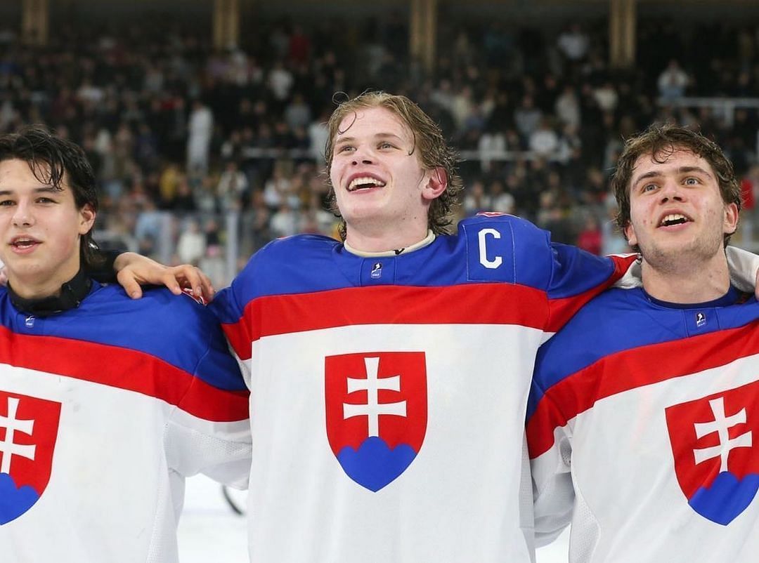 Maxim Strbak (center)