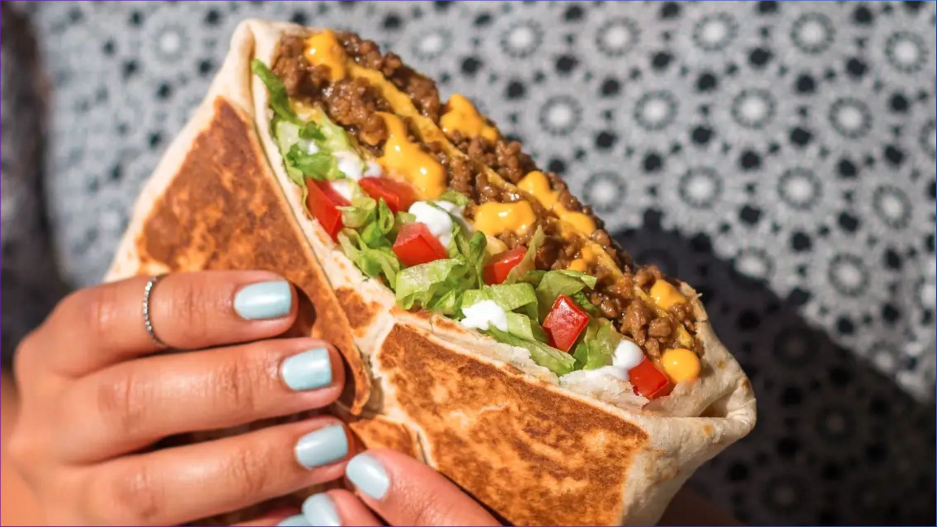 The Triple Double Crunchwrap can now be enjoyed as part of new 3-course and 5-course meals (Image via Taco Bell)