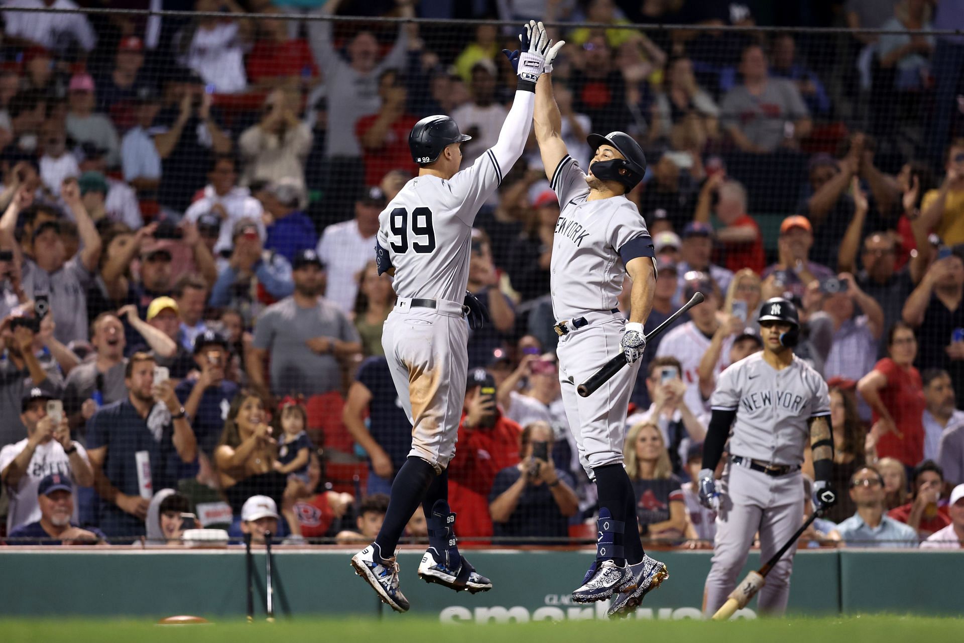 Aaron Judge of the New York Yankees celebrates with Giancarlo Stanton after hitting a home run at Fenway Park