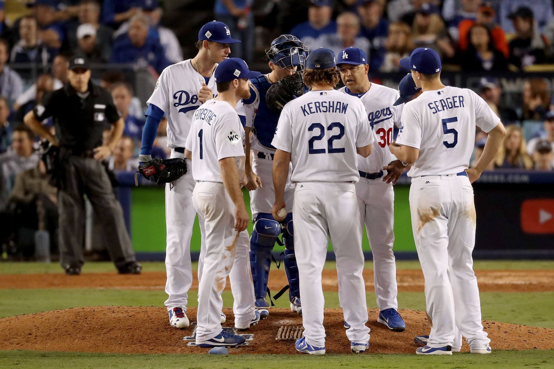 Clayton Kershaw of the Los Angeles Dodgers meets with teammates and manager Dave Roberts in game seven of the 2017 World Series