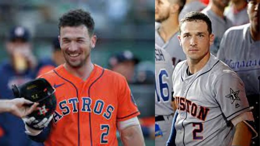 Houston Astros' Alex Bregman, left, points to a camera after