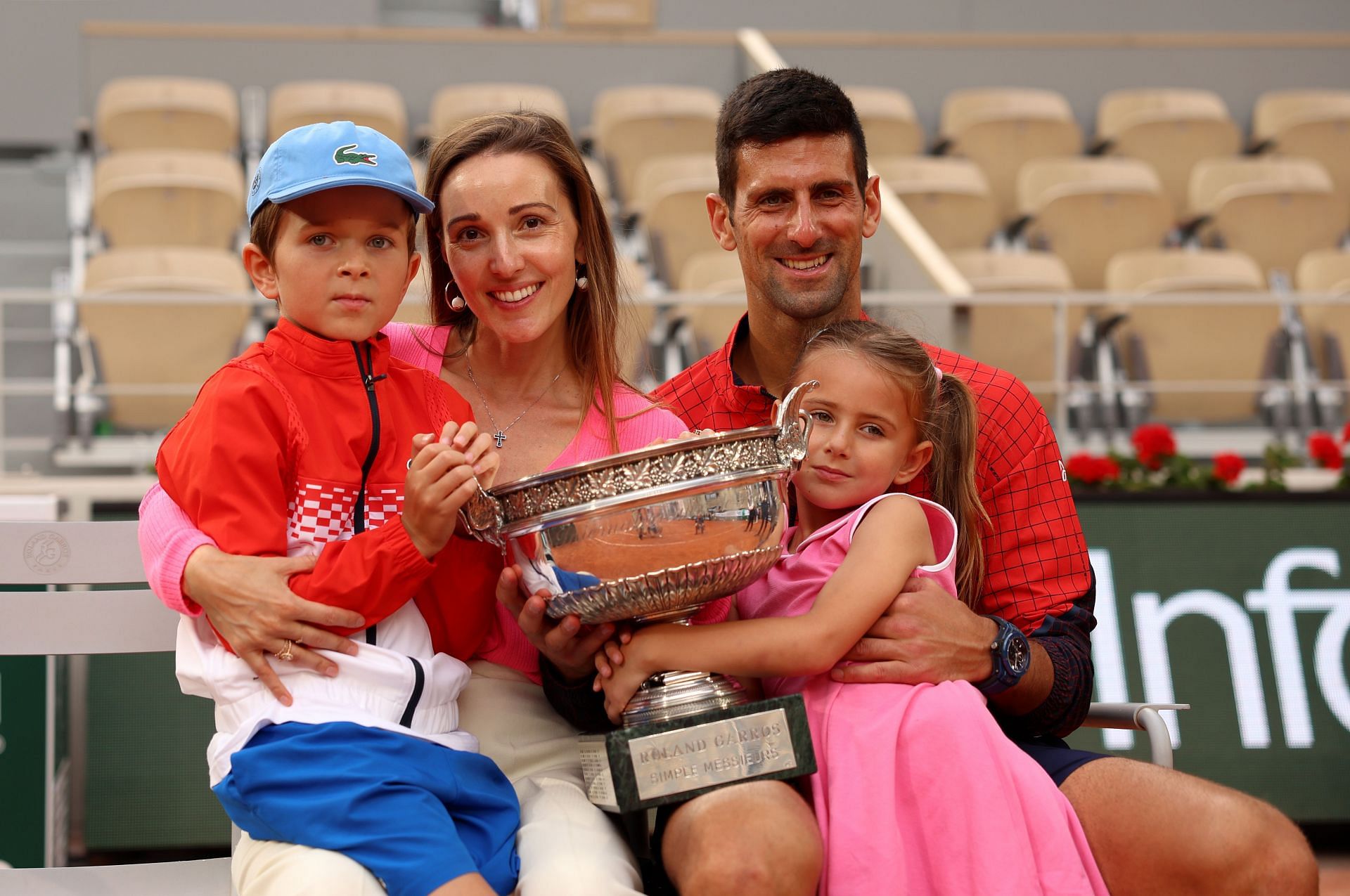 Novak Djokovic, his wife Jelena, and his kids pose with the 2023 French Open trophy