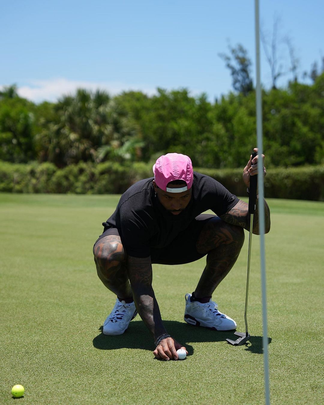 Beckham Jr. lining up his putt. Photo via DJ Khaled Instagram.