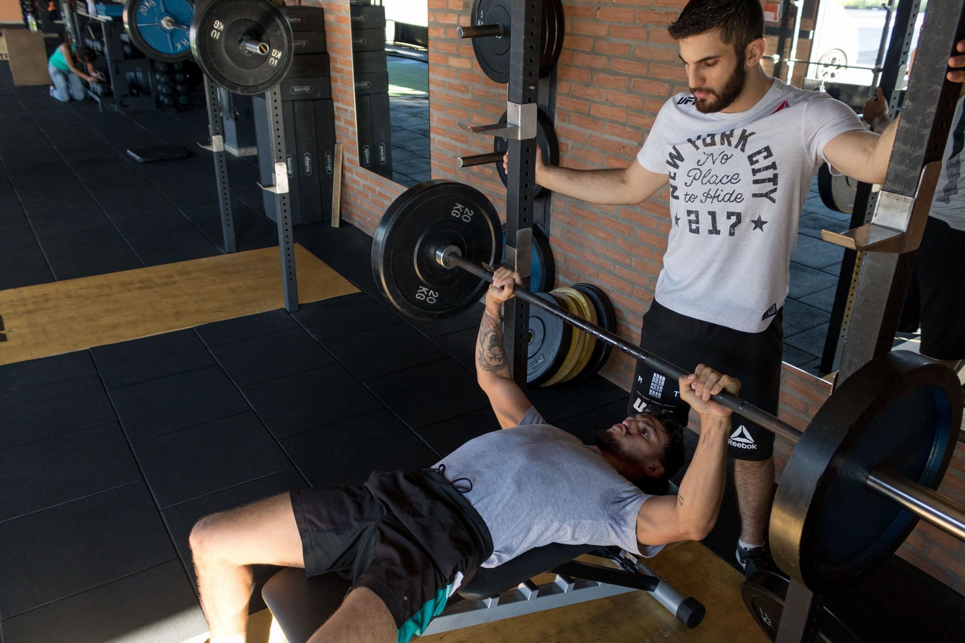 Bench press can be performed by lying down or standing. (Image via Pexels/Bruni Bueno)