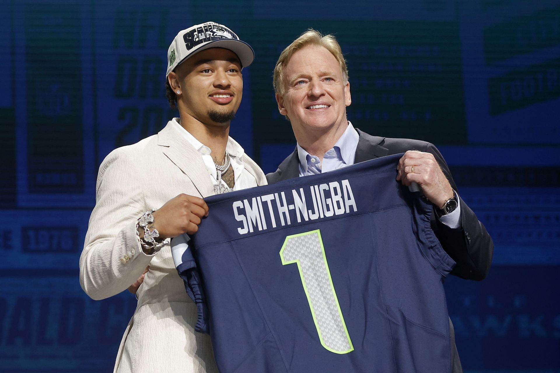 Jaxon Smith-Njigba poses with NFL Commissioner Roger Goodell after being selected 20th overall by the Seattle Seahawks 
