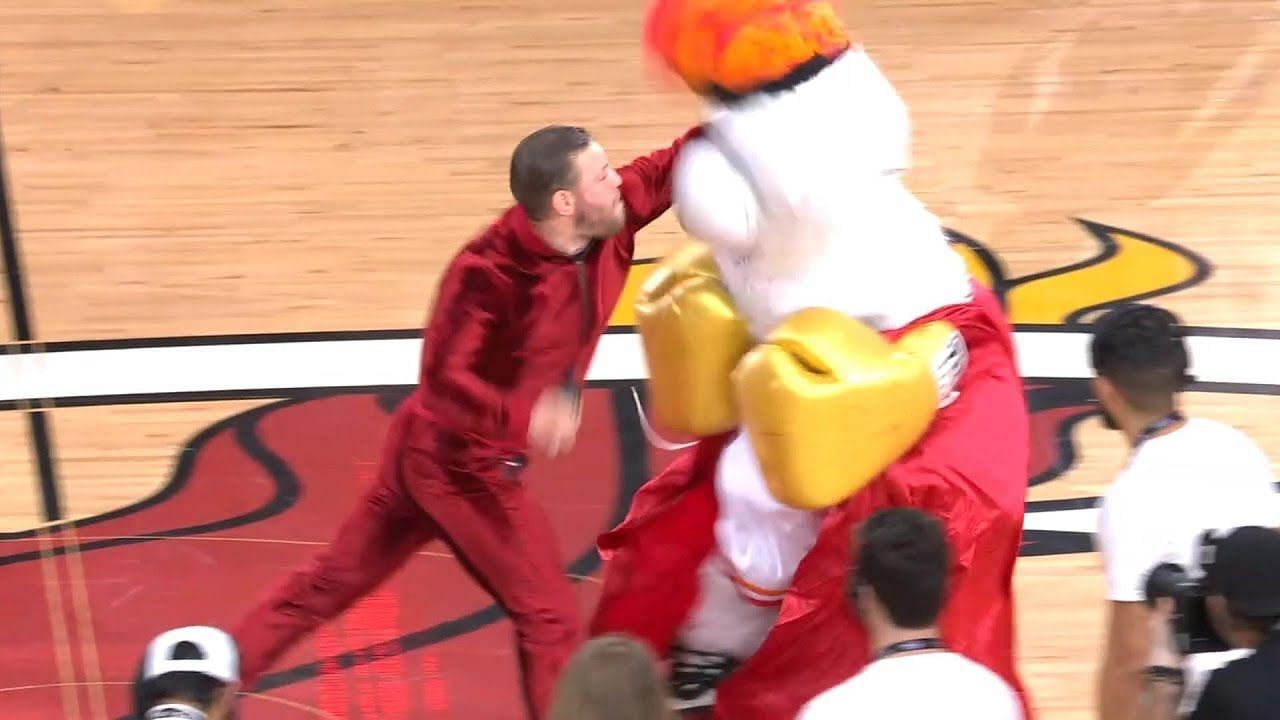 Conor McGregor throws a left hook at the Heat mascot