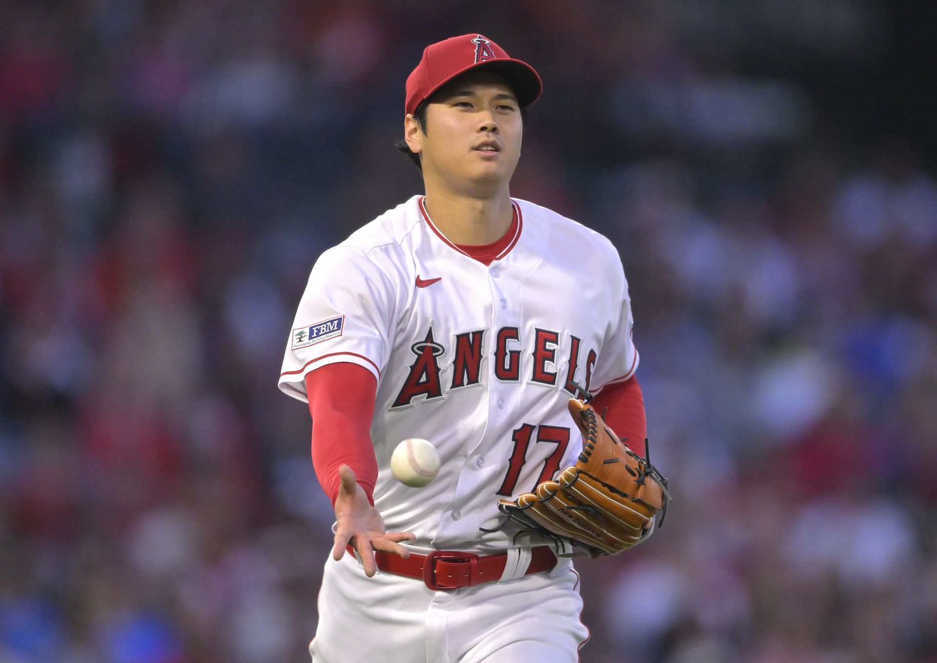 Shohei Ohtani of the Los Angeles Angels throws to first base in the third inning at Angel Stadium of Anaheim