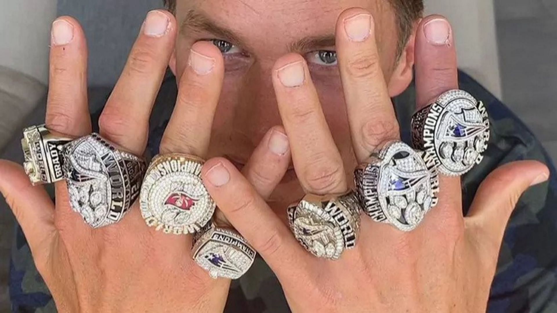 Former NFL quarterback Tom Brady flaunting his seven Super Bowl rings