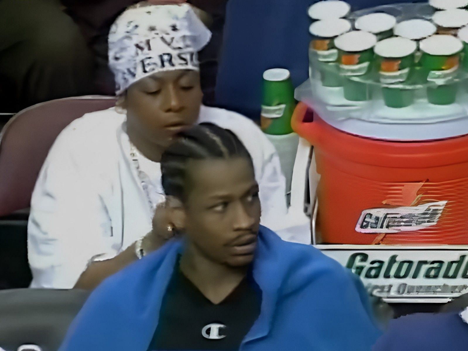 Philadelphia 76ers legend Allen Iverson getting his hair braided by his mother during a Sixers game
