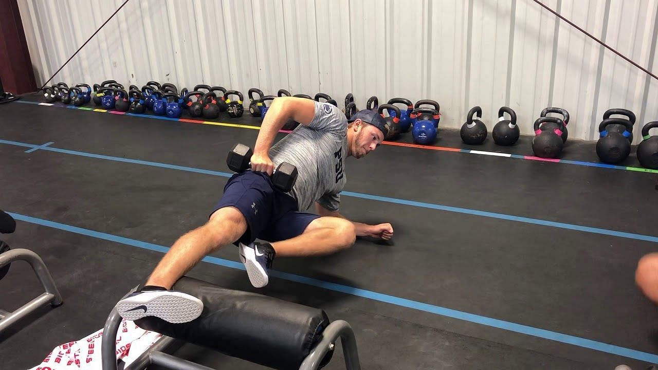 To enhance the level of difficulty for the Copenhagen Plank, incorporating weights can be beneficial. (Image via Next Level Rochester/ Youtube)