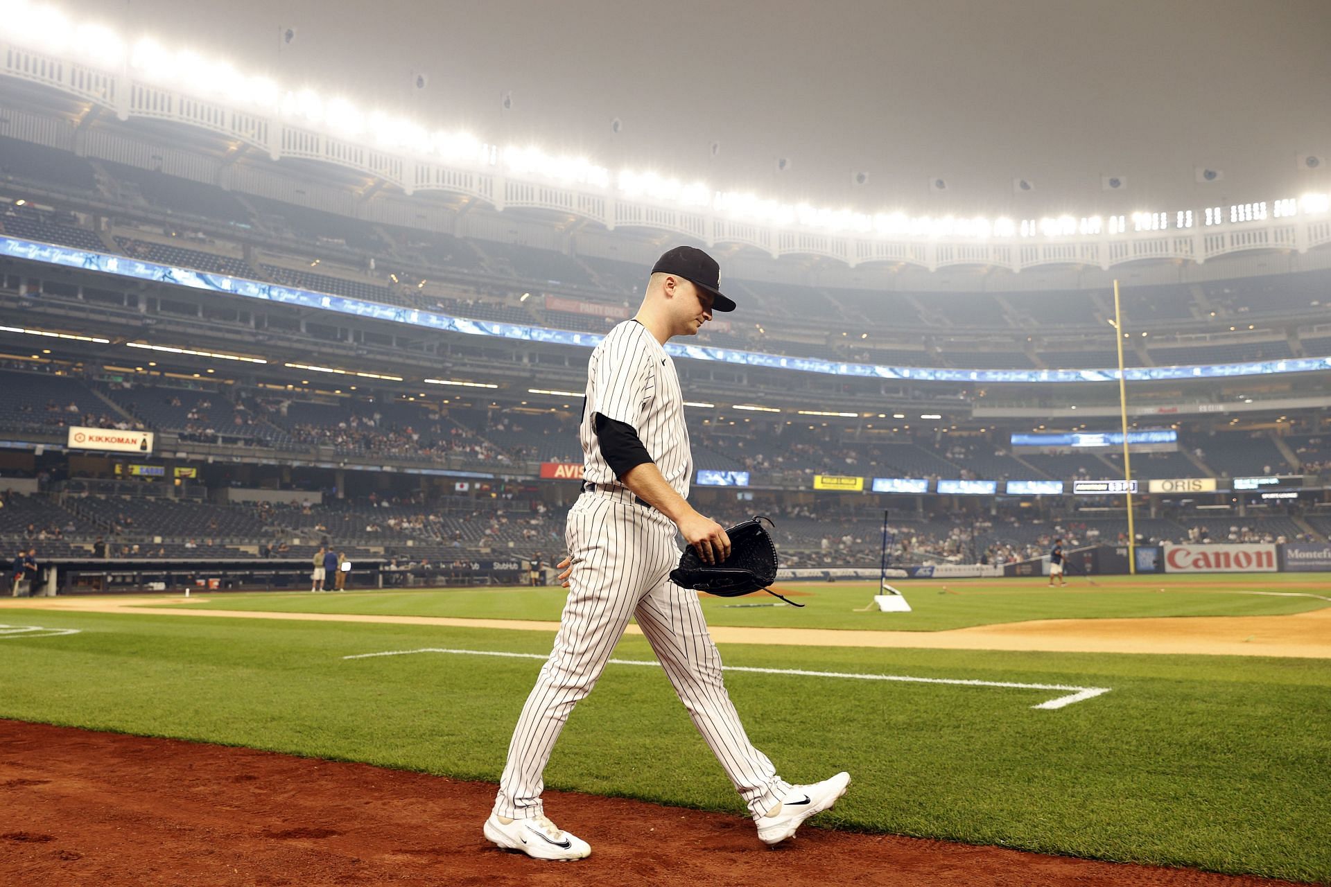 General view of hazy conditions resulting from Canadian wildfires as Clarke Schmidt of the New York Yankees walks onto the field before facing the Chicago White Sox at Yankee Stadium on June 6.