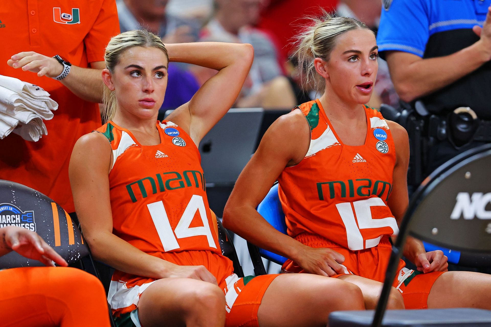 Haley Cavinder #14 and Hanna Cavinder #15 of the Miami Hurricanes sit on the bench during Miami v Villanova