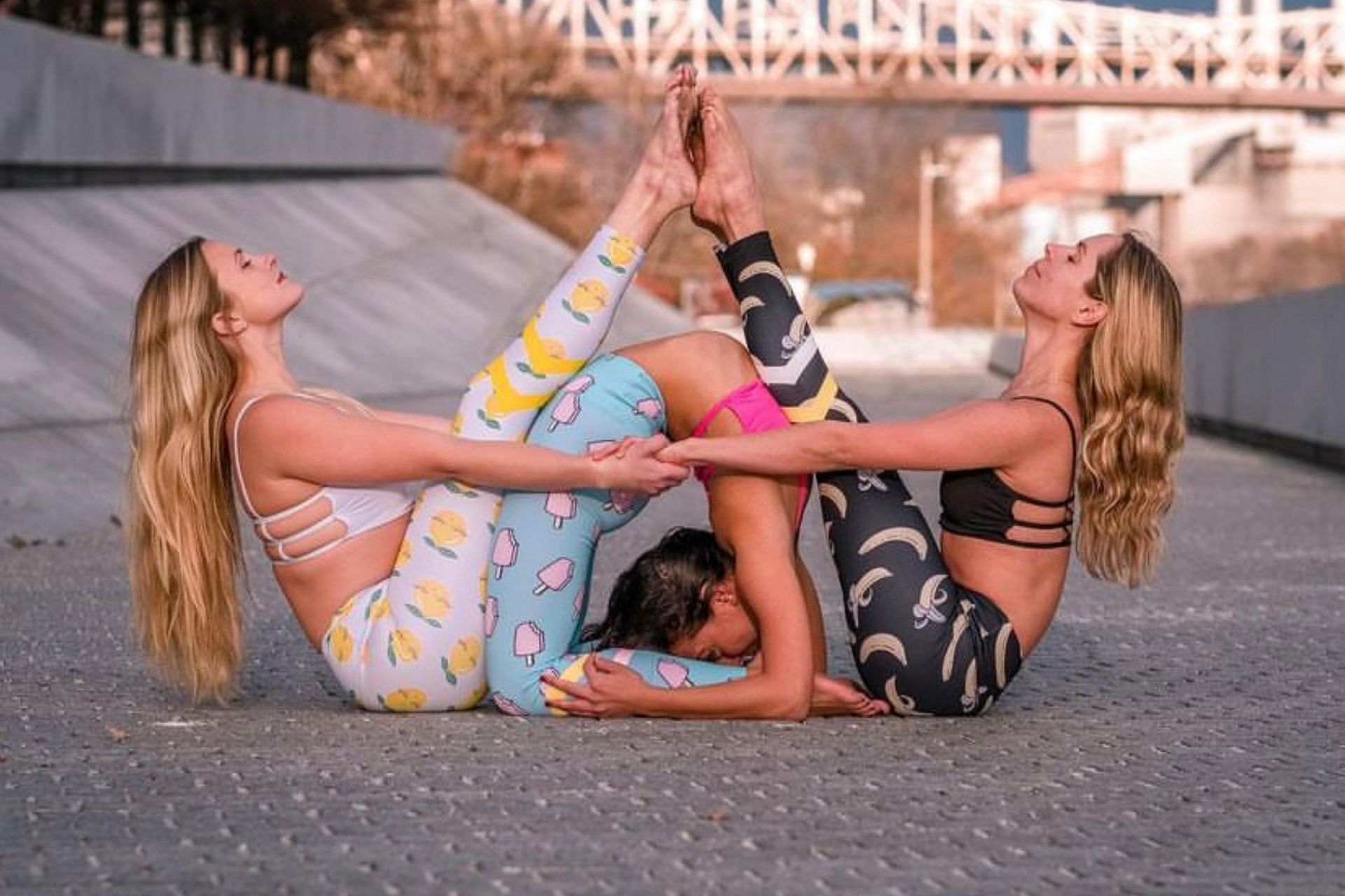 Doing 3-person yoga requires strength and coordination. (Photo via Instagram/reneechoiphotography)