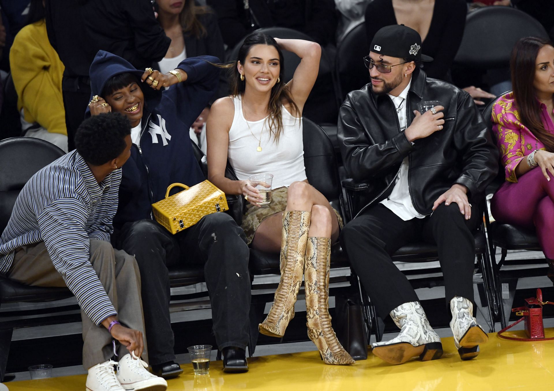Kendall Jenner sits beside Bad Bunny at a Lakers playoff game.