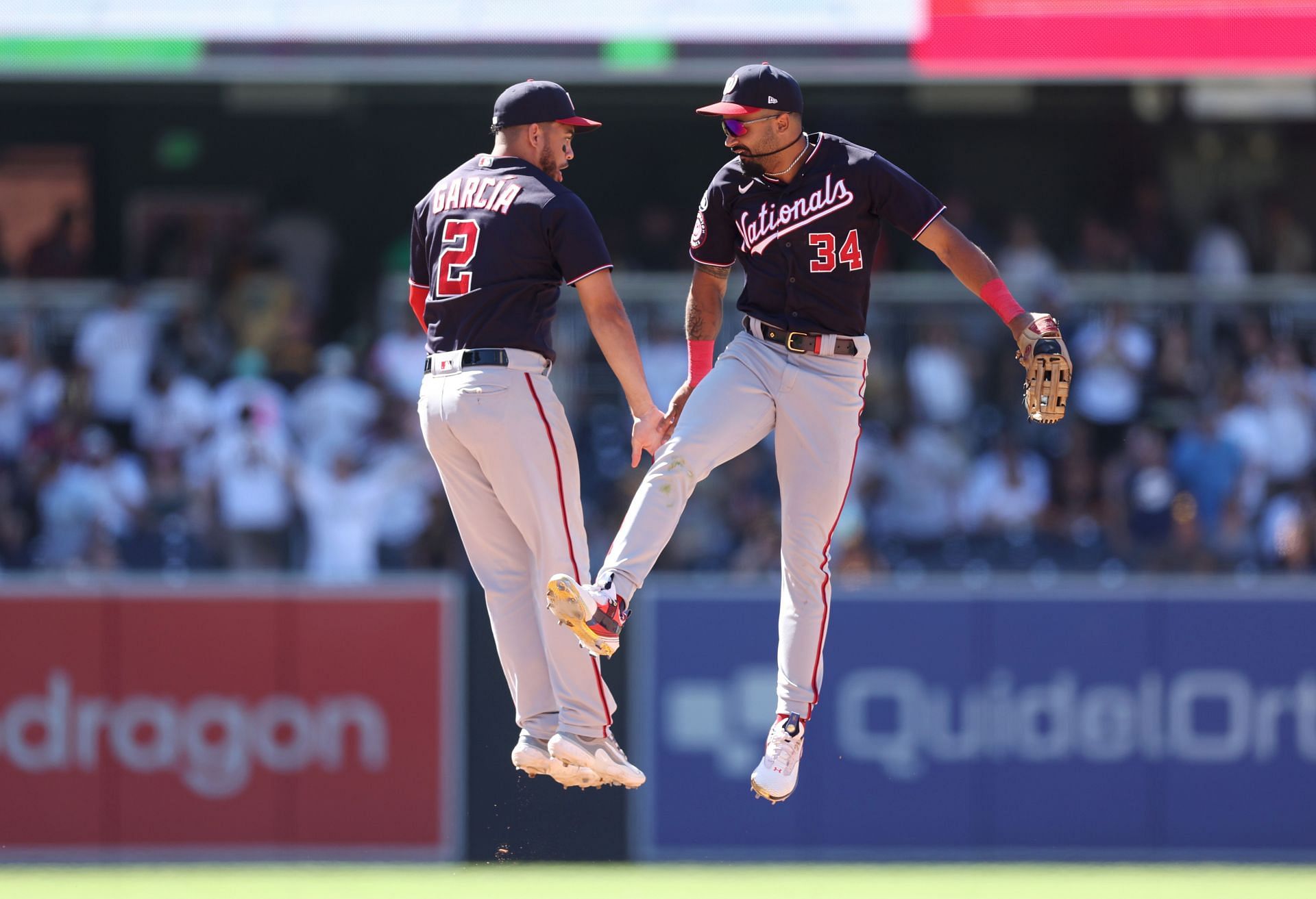 Luis Garcia of the Washington Nationals celebrates with Derek Hill after defeating the San Diego Padres 8-3 at PETCO Park on Sunday.