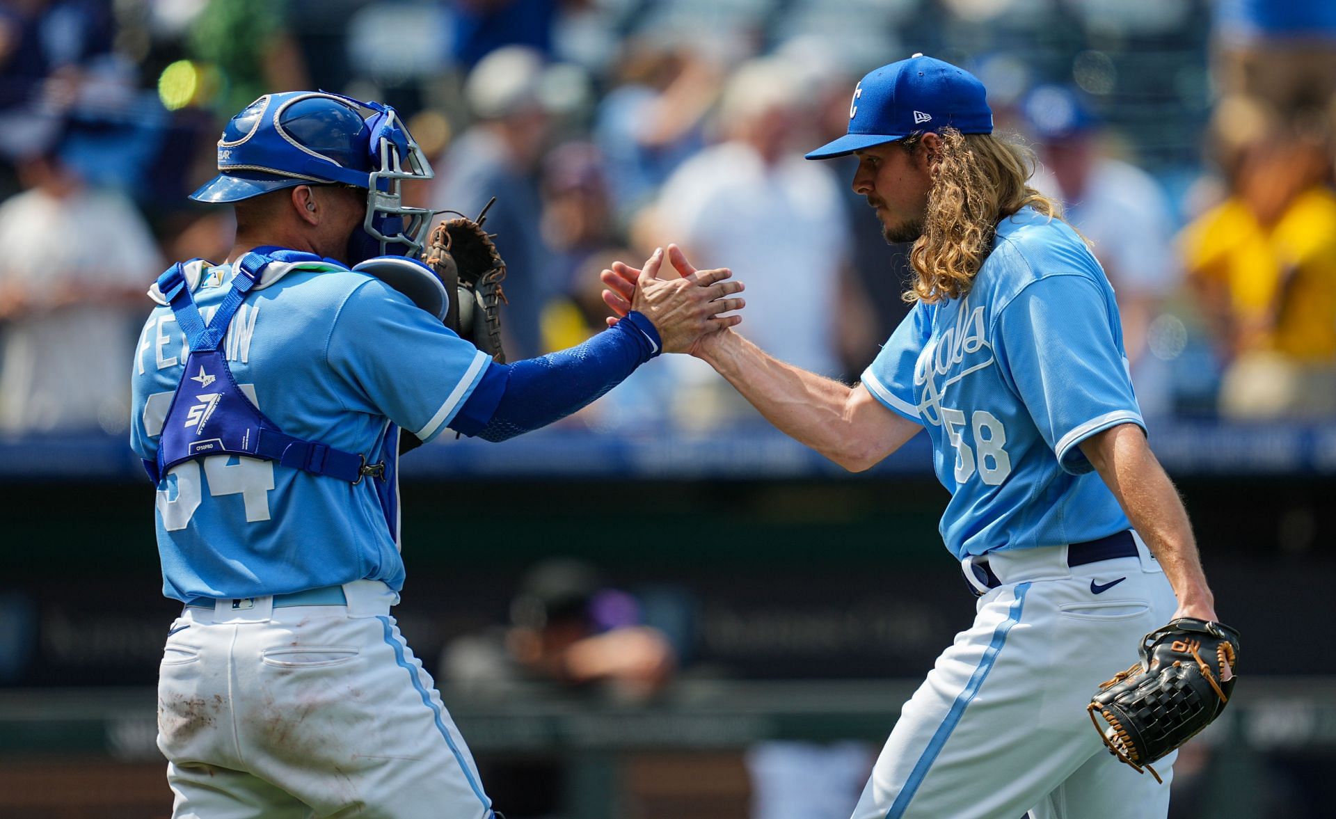Freddy Fermin #34 of the Kansas City Royals celebrates with Scott Barlow #58 after a game against the Colorado Rockies