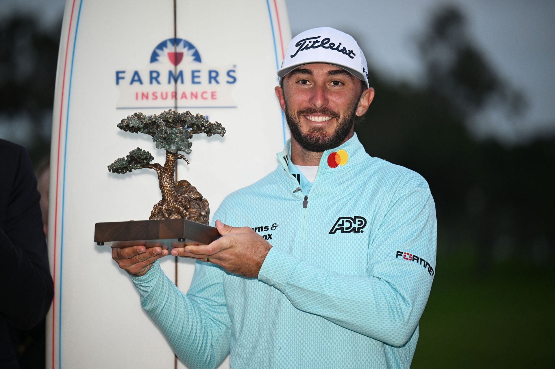 Max Homa with Farmers Insurance Open Trophy in January (via Getty Images)
