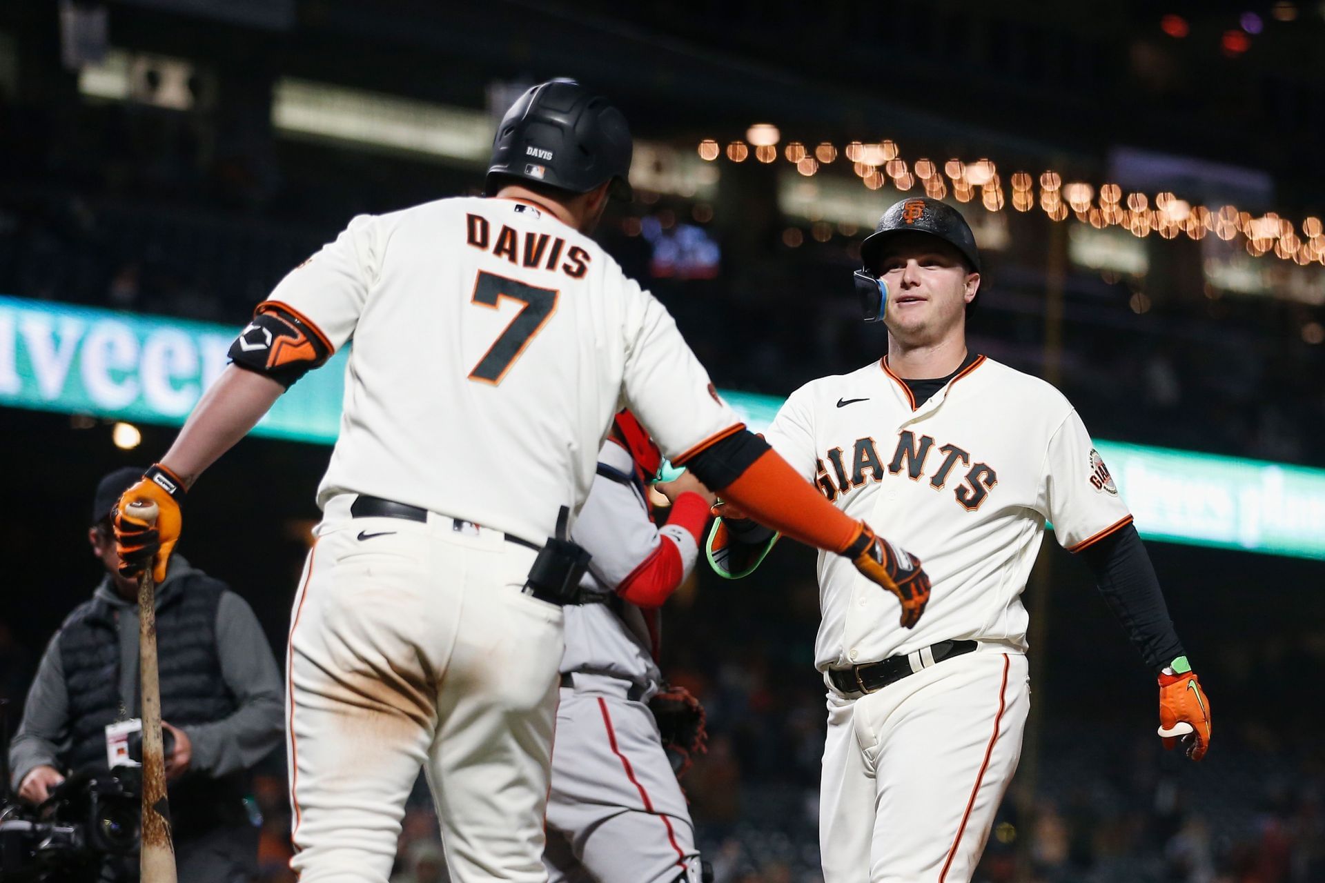 Joc Pederson celebrates with J.D. Davis after hitting a solo home run at Oracle Park