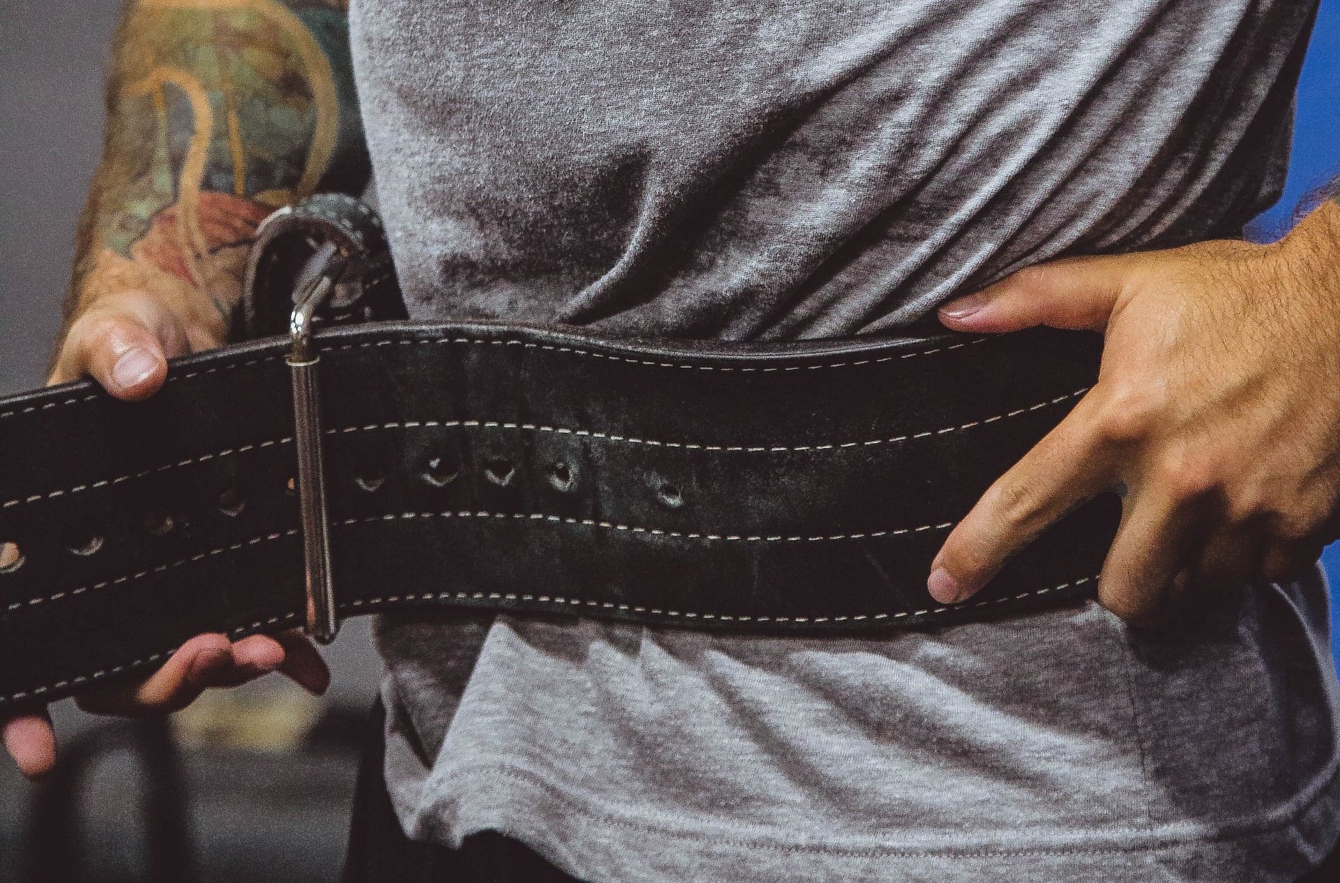 Using lifting belts (Photo by Alora Griffiths on Unsplash
