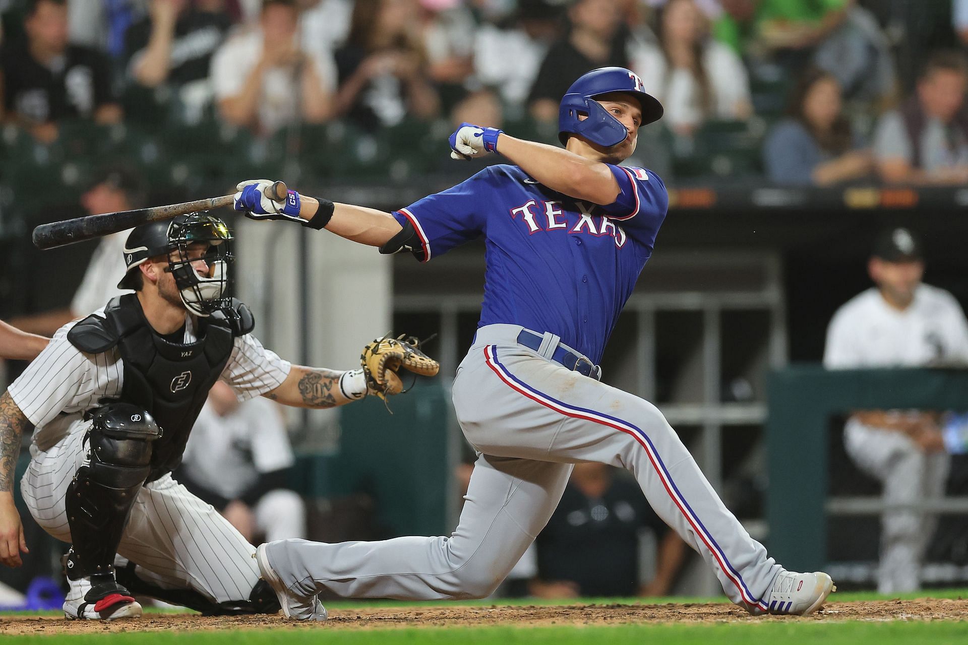 Corey Seager #5 of the Texas Rangers hits a two-run single during the seventh inning against the Chicago White Sox