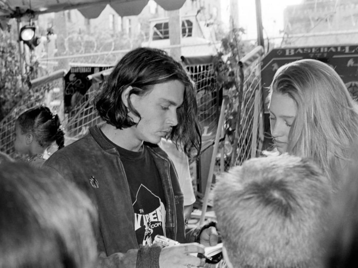 Johnny Depp mingling with fans signing autographs (Image via Getty)