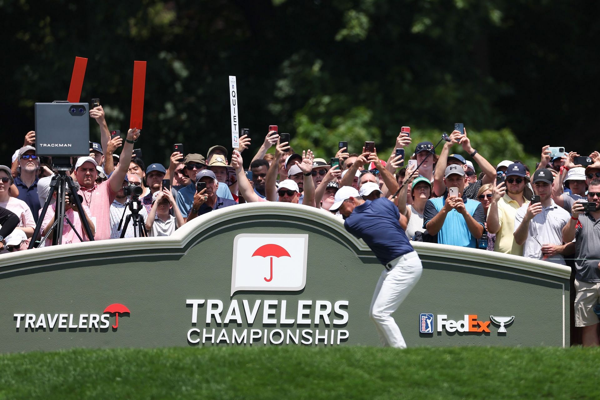 Rory McIlroy plays his shot from the first tee during the final round of the Travelers Championship at TPC River Highlands