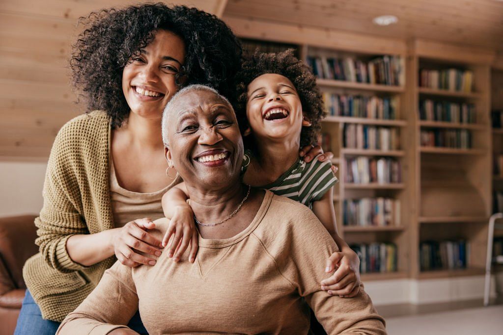 Family members taking care of grandmother(Image via Getty Images)