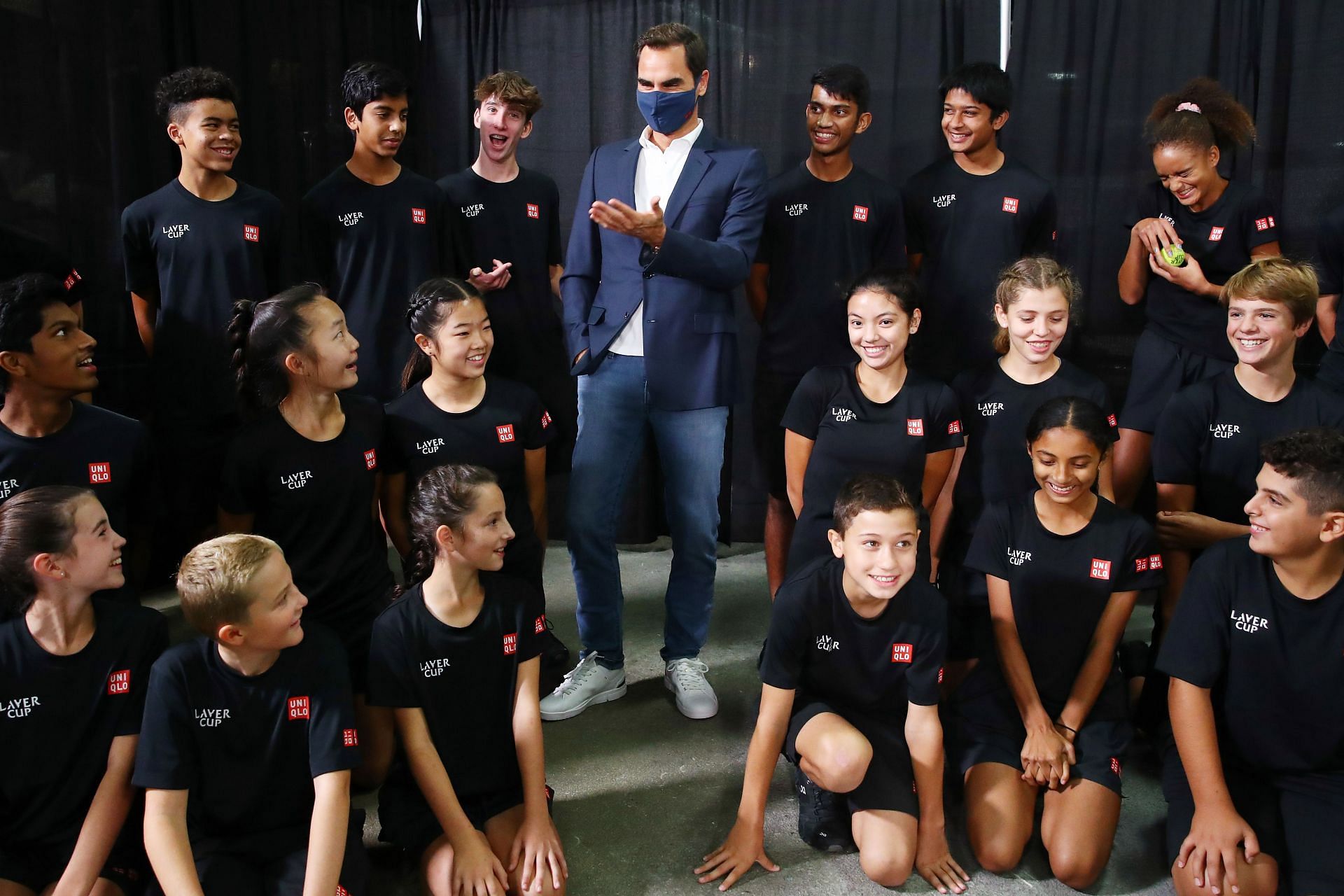 Roger Federer with the ball kids