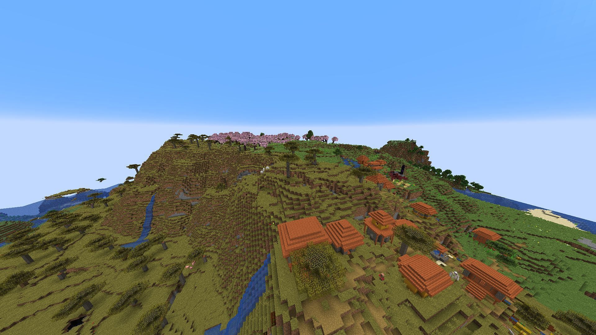 The savanna village in this seed with the cherry blossom biome near spawn visible in the distance (Image via Mojang)