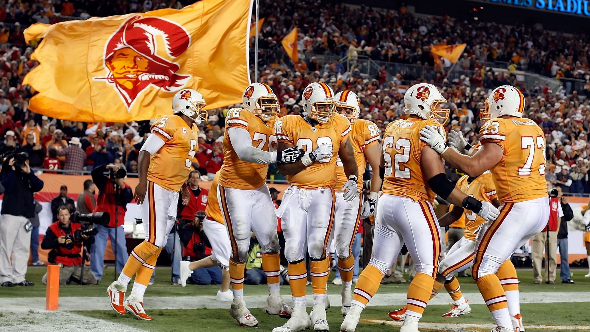 The Tampa Bay Buccaneers celebrates in their creamsicle uniform