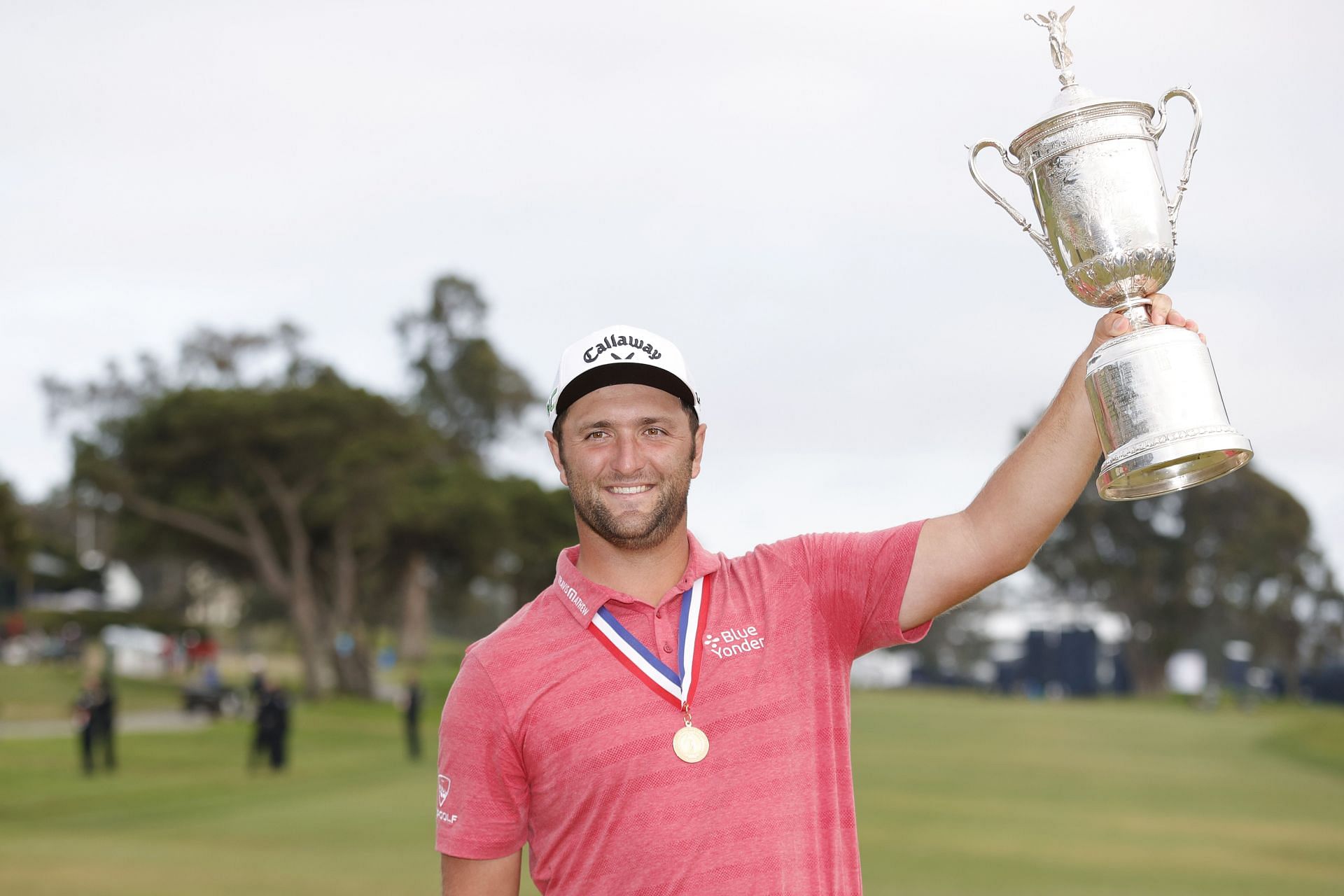 Jon Rahm wearing the Jack Nicklaus medal and holding the U.S. Open Trophy in 2021 (via Getty Images)