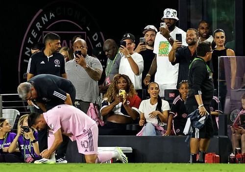 LeBron, Kim and Tristan watch from the sidelines as Messi prepares to sub in