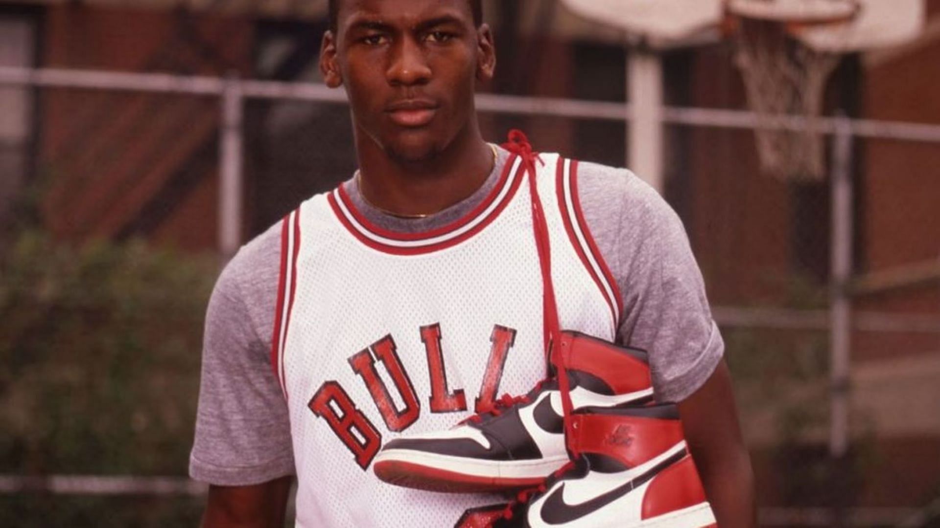 Michael Jordan posing with his shoes
