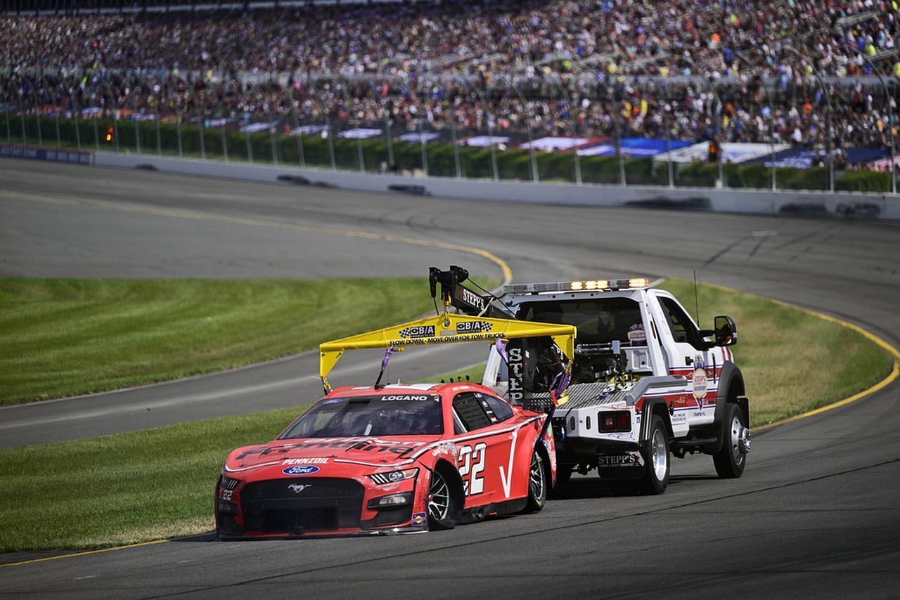 Joey Logano is towed back to the pits after an accident during a NASCAR Cup Series auto race at Pocono Raceway, Sunday, July 23, 2023, in Long Pond, Pa. (AP Photo/Derik Hamilton)