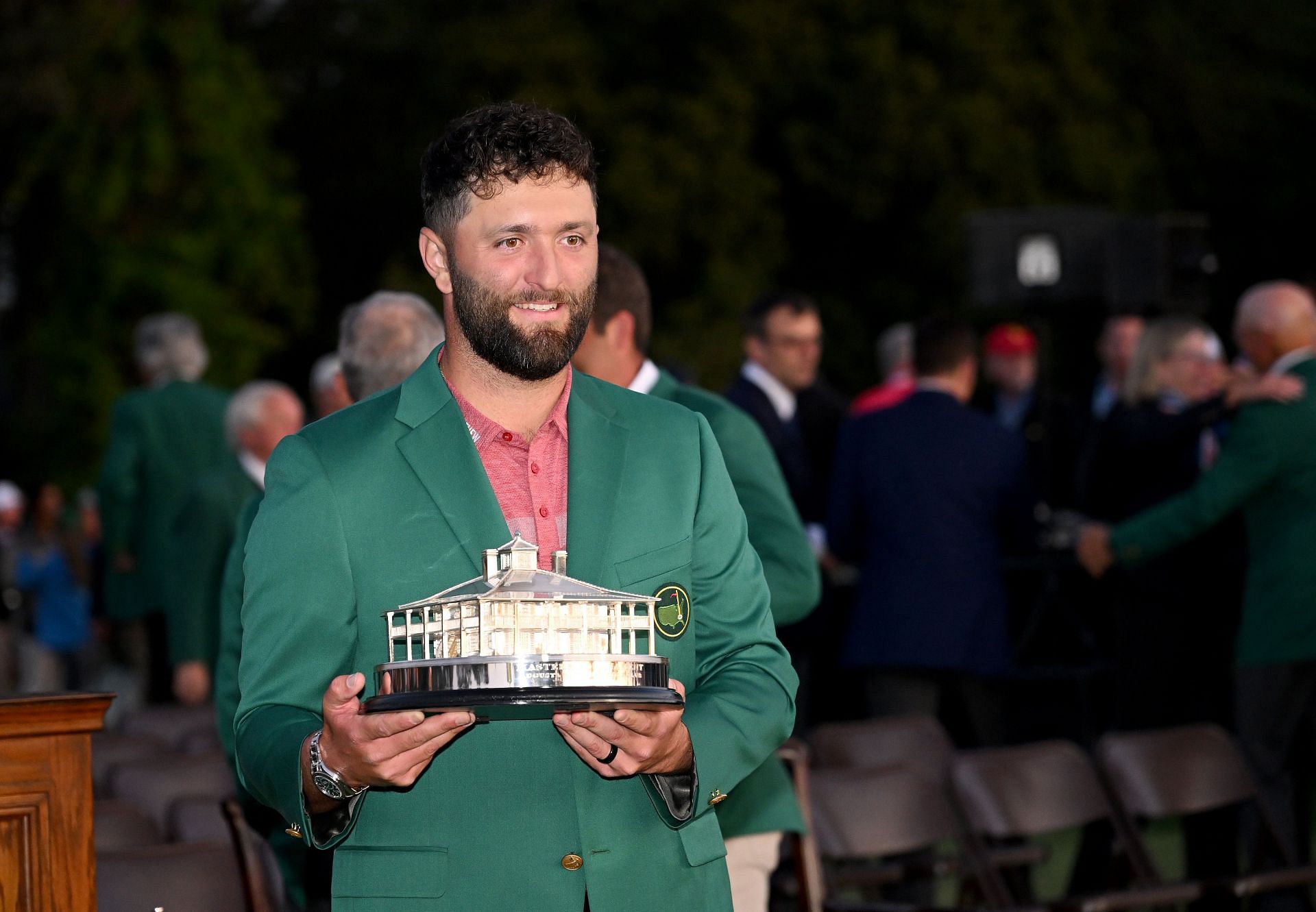 Jon Rahm wearing the prestigious green jacket and holding the Masters trophy, 2023 (via Getty Images)