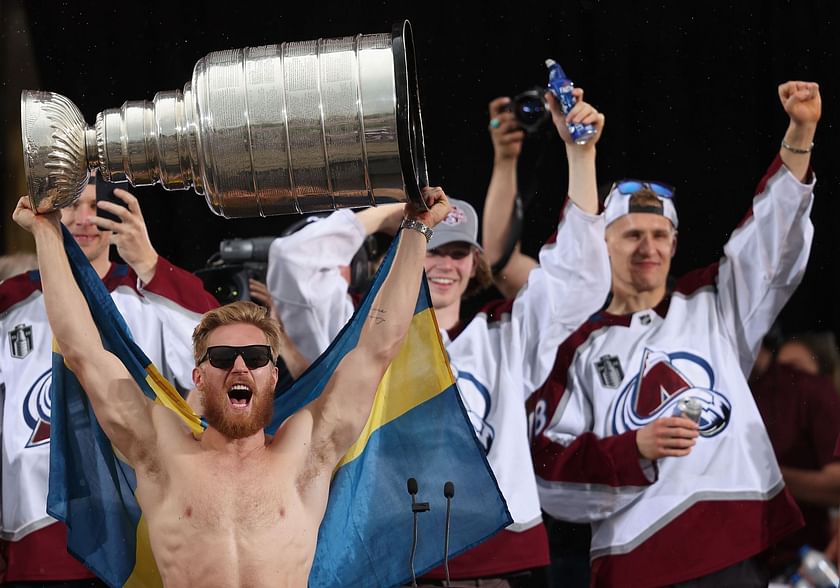 Erik Johnson and Gabriel Landeskog of the Colorado Avalanche hoist