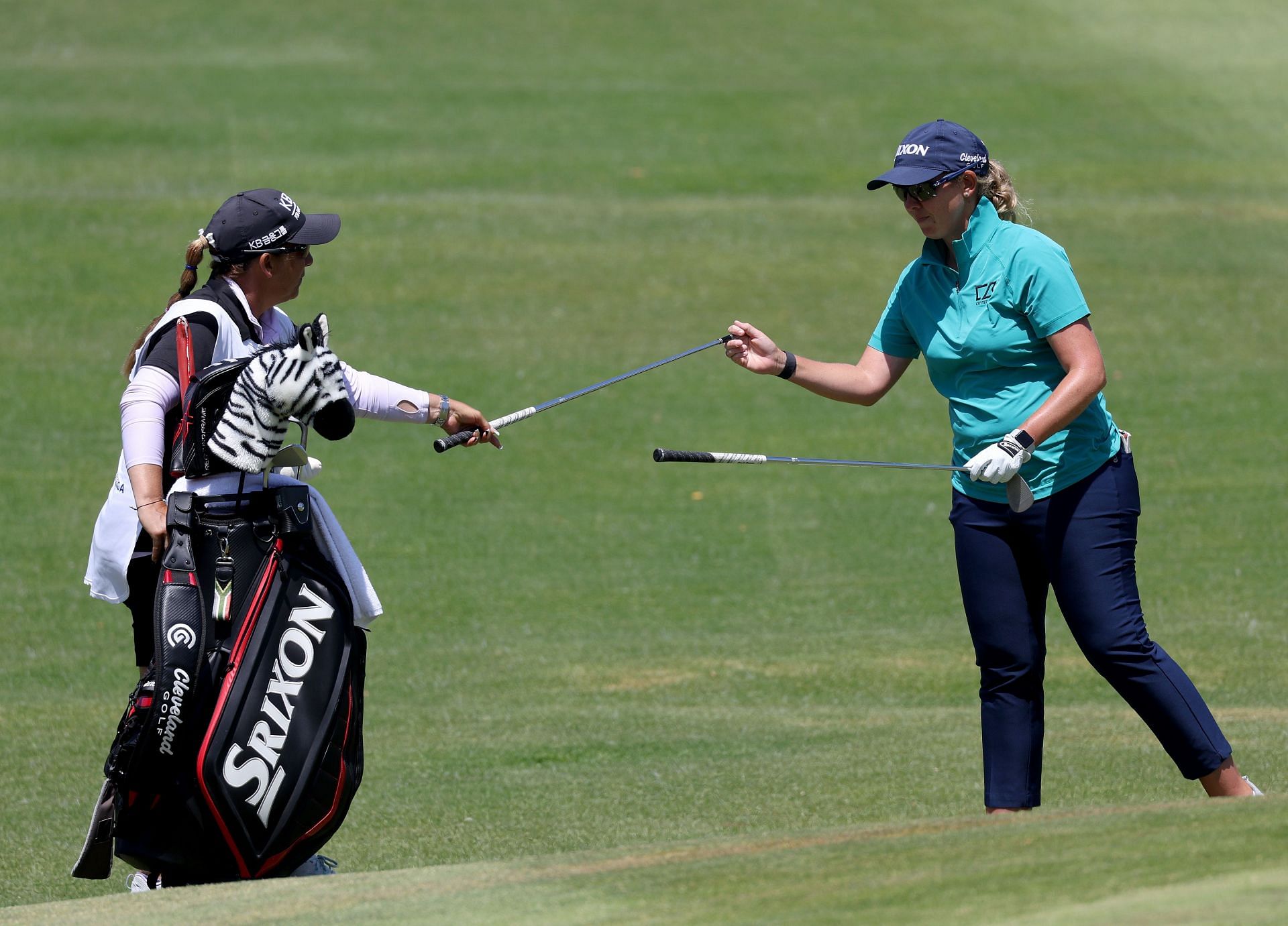 Ashleigh Buhai switches clubs with her caddie Tanya Paterson during the final round of the Palos Verdes Championship 2022
